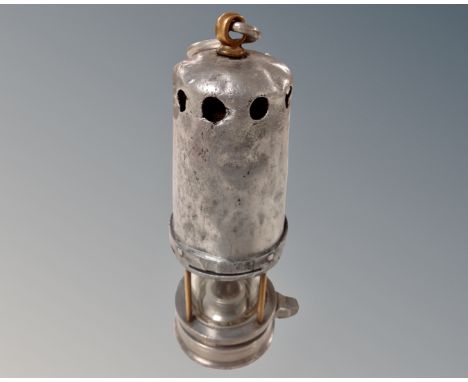 A late 19th century miner's lamp. CONDITION REPORT: Original finish removed.