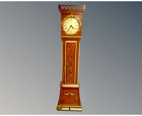 A Continental painted longcase clock with circular dial, pendulum and weights.