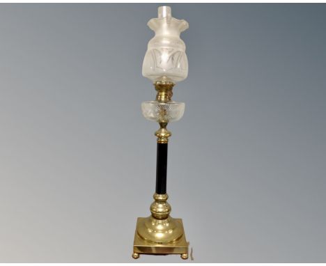 An impressive 19th century oil lamp on ball feet with etched glass reservoir, opaque shade and chimney. (height 92cm)