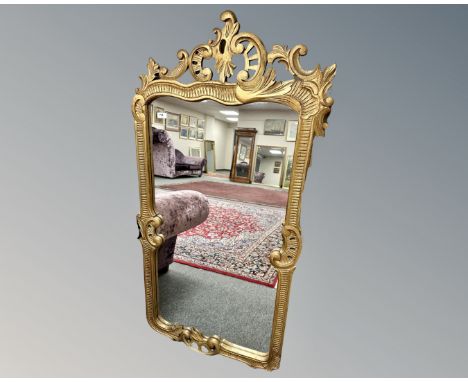 A continental mirror in gilded wood frame, 73cm by 144cm.