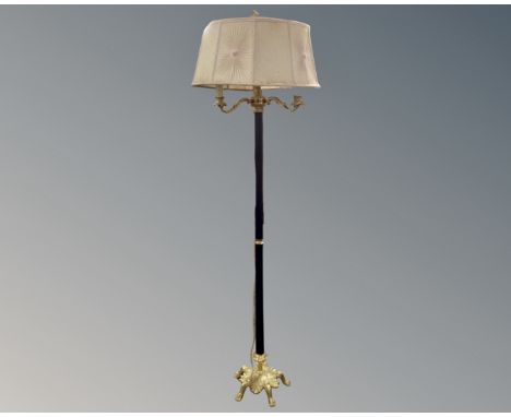 A decorative metal and brass three way standard lamp with shade. CONDITION REPORT: Continental wiring.