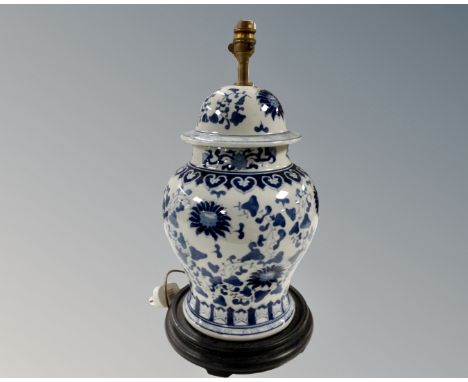 A Chinese blue and white lidded vase on wooden stand, height 42cm, converted to a table lamp 