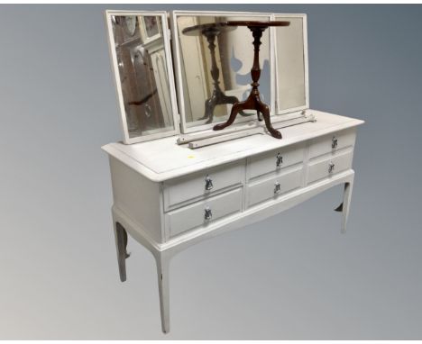 A Stag Minstrel painted six drawer dressing table with triple mirror together with a wine table.