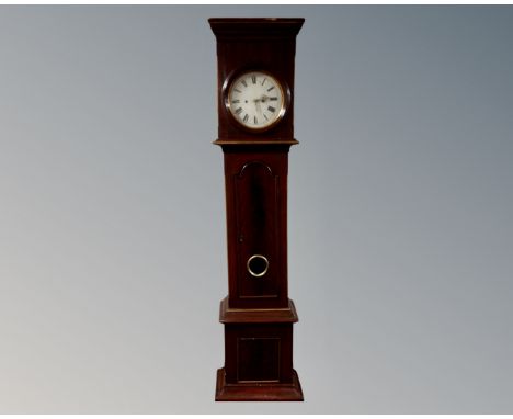 A 19th century mahogany longcase clock with painted dial, pendulum and weights.