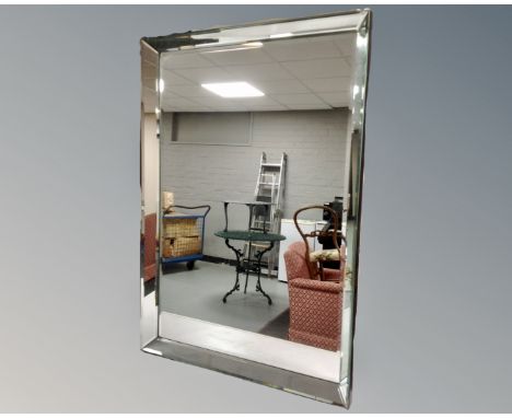 A contemporary all glass framed bevel edged mirror.