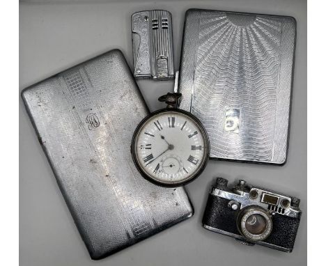 A Sterling silver pocket watch, key wound, along with two chrome plated cigarette cases, a novelty camera lighter. made in oc