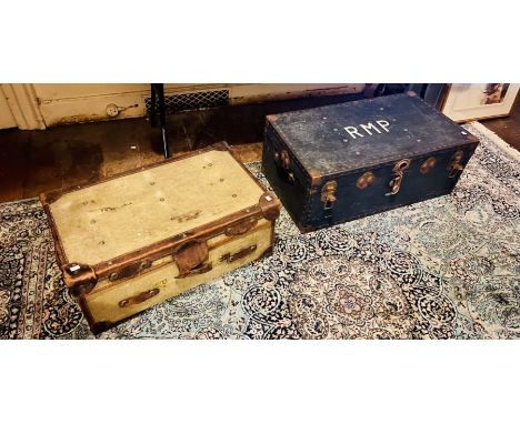 A pair of travel trunks: An early 20th century leather mounted travel trunk with brass lever locks; A brass mounted plywood m