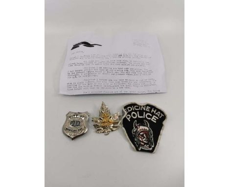 Three "Medicine Hat" Canadian police badges. Comprising a fabric patch. a maple leaf hat badge and a shield badge in white me