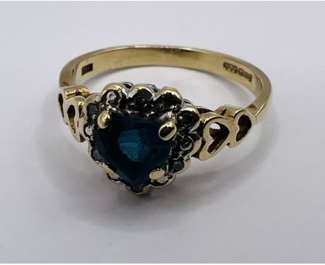 A 9ct gold diamond and London blue topaz heart dress ring. Size K. Gross weight approximately 2.0 grams.