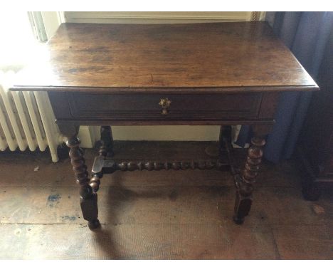 A late 17th Century joined oak side table, fitted with a single drawer, raised on bobbin turned legs, united by stretchers