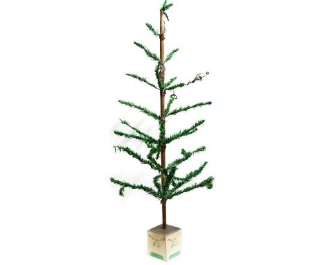 A 1930's Christmas tree, mounted on a painted wooden stand, with some decorations to include 1930's glass baubles and vintage