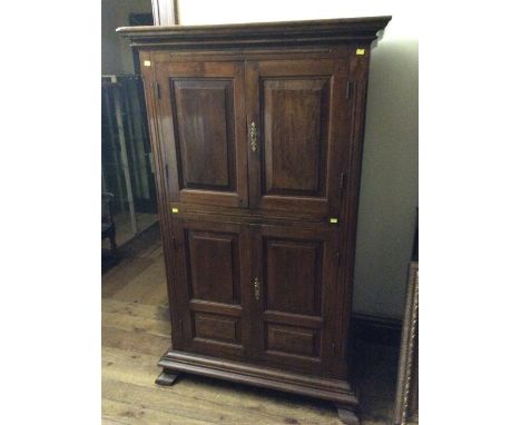 A George III oak and chestnut hall cupboard, circa 1770, moulded cornice, two panelled doors opening to a two tier shelf abov