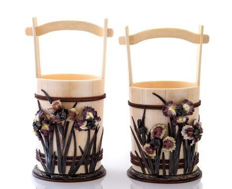 A pair of Japanese ivory baskets, Meiji period, 1868-1912, in the form of a ropework bound handled baskets with applied ename