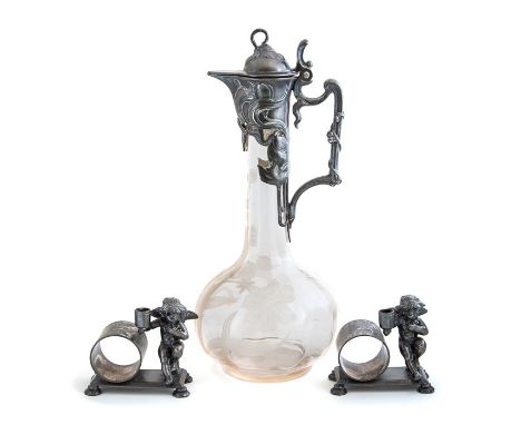 A WMF Art Nouveau pewter mounted claret jug, circa 1905, hinged cover with thumbpiece, the globe and shaft glass body with ac