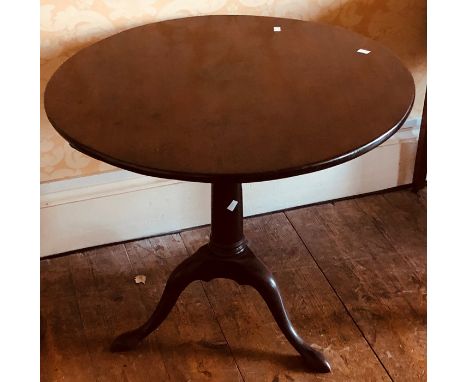 A George III mahogany circular occasional table, circa 1800, turned column on tripod platform on cabriole padded feet.