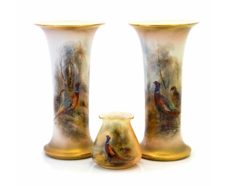 James Stinton for Royal Worcester, a pair of trumpet shaped vases, each painted with pheasants in wooded landscapes, signed, 