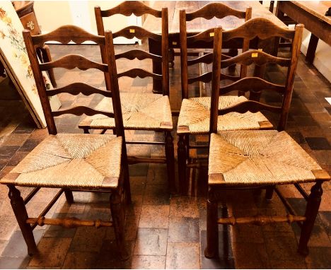 A set of four 19th century ladder back elm rush seated chairs.&nbsp;