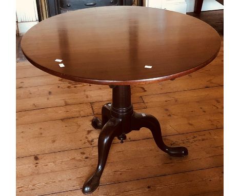 A George III mahogany circular occasional table, circa 1800, turned column on tripod platform on cabriole padded feet.