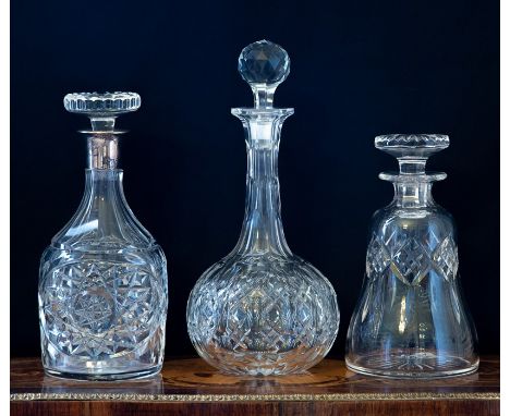 Three clear cut glass decanters and stoppers 19th Century and later, one a mallet shape with white metal collar, one a globe 