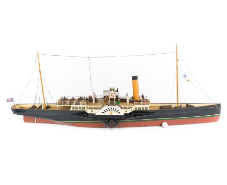 A wooden twin masted model of a Victorian/Edwardian coastal Paddle Steamer. An electrically powered scale model of a Southern