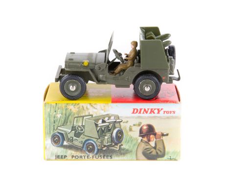 French Dinky Military Rocket Carrier Jeep (828). In olive green, complete with driver and rockets. Boxed. Vehicle Mint. Plate