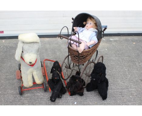 A group of vintage soft toys, a modern doll and ornamental Victorian styled pram. Lot includes three vintage black soft toy p