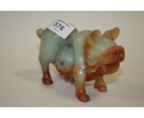 AN ORIENTAL JADE STYLE CARVING OF A PIG