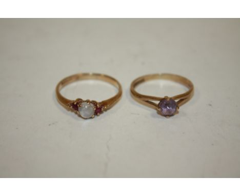 A HALLMARKED 9CT GOLD DRESS RING SET WITH A PURPLE STONE TOGETHER WITH A HALLMARKED 9CT GOLD MOON STONE AND RUBY RING (2)