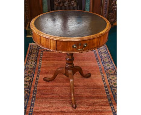 A George III mahogany drum rent table of small proportions, the circular top with inset faux-leather and three frieze drawers