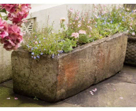 A rectangular stone trough 35½ x 13½in. (90 x 34.5cm.), 11¾in. (30cm.) high.