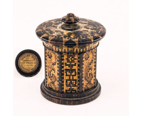 A Tunbridgeware inkwell by Edmund Nye octagonal column form with turn-off disc cover with bun finial, glass well, on a circul