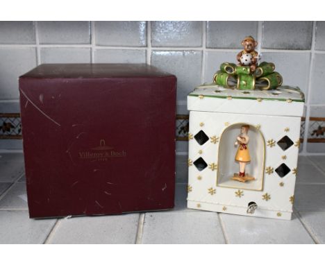 A boxed Villeroy & Boch 'Christmas' musical nightlight in the form a ribbon tied box, the cover with teddy bear bow finial, t