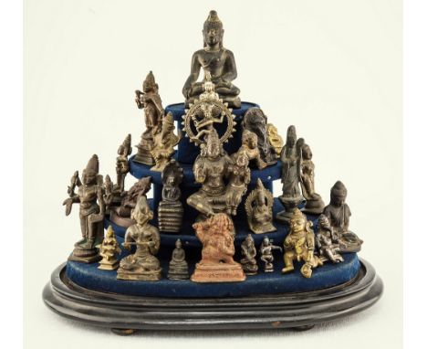 A collection of Indian and Oriental miniature bronze, brass and white metal figures of deities 19th-20th century, the twenty-