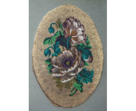 A Victorian framed beadwork panel oval, depicting a spray of peonies, the beadwork 15½ x 11¾in. (39.5 x 30cm.).