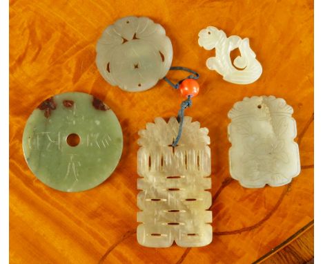 Five antique Chinese jade carvings comprising a celadon jade disc with russet inclusions, both sides inscribed with archaisti