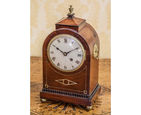A George IV brass and ebony strung mahogany mantel clock the arched case with peaked top with brass urn finial, gilt pressed 