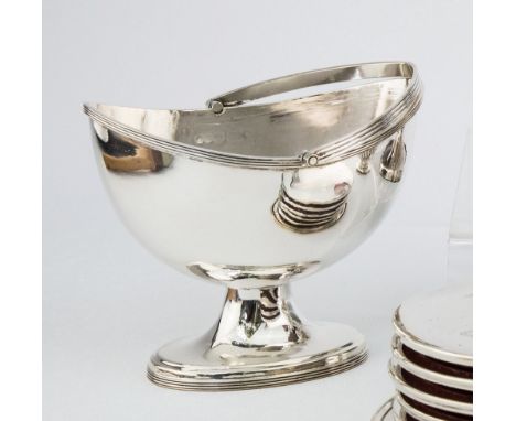 An Elizabeth II silver swing handled sugar basin Richards & Knight, London 1969, of navette form with reeded Gothic arched ha