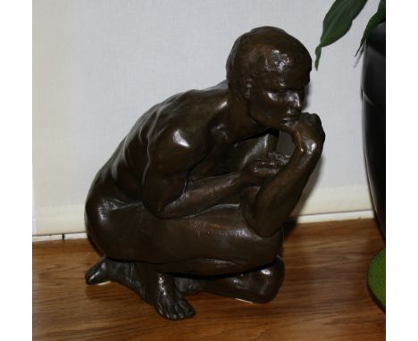 A cold cast bronze of a kneeling male nude signed and dated indistinctly, numbered 497/1000, 13in. (33cm.) high.