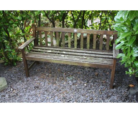 A teak garden bench with slatted seat and back, 62in. (157.6cm.) wide, height of back 30in. (76.2cm.).