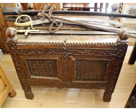 An antique Indian carved two panel chest with half lifting lid and block toes, 27½ x 17½in. (68.5 x 44.5cm.), 22½in. (57cm.) 