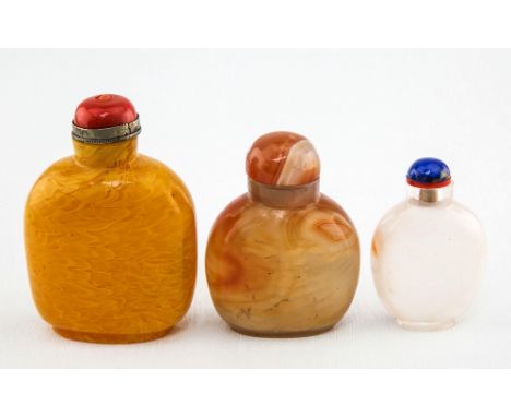 A Chinese carved agate snuff bottle 20th century, of ovoid form, with matching domed stopper, 6.7cm. high; together with a ye