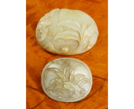 An antique Chinese jade belt buckle probably 18th century, in pale green and russet mottled jade, of domed oval form with a b