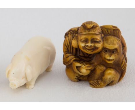 A Japanese carved ivory netsuke of a seated man and a macaque Meiji period, signed, 3.8cm. high; together with a carved ivory