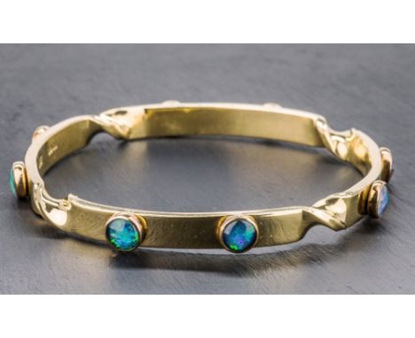 A Catherine Best 18ct gold and opal bangle the heavy gold bangle with twist decoration, set with eight cabochon opals, in ori