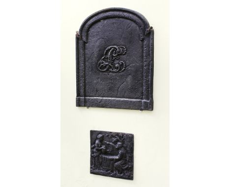 A small, stepped arch-topped cast iron fire-back centrally decorated with raised script initials LE within a raised beaded bo