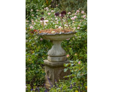 A composite stone shallow urn planter on square pedestal base, originally a fountain, 27in. (68.7cm.) diameter, 36in. (91.5cm