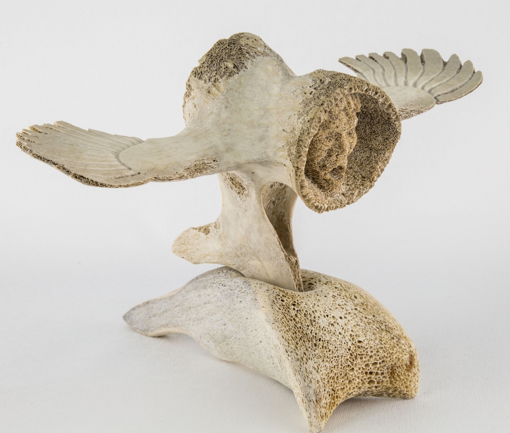 An unusual Inuit carved whale bone figure by Joe Nasogaluak