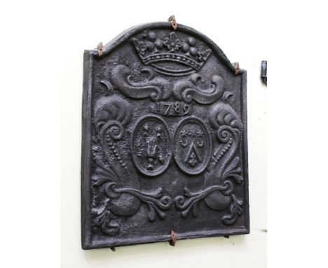 An arch-topped cast iron fire-back with raised decoration of a crown above two horizontal, scrolled leaves with the date 1798