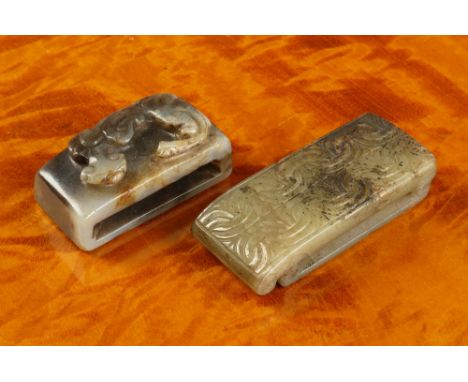 Two antique Chinese carved jade sword slides possibly Han Dynasty (206BC-220AD), one pale grey-green jade with dark brown inc