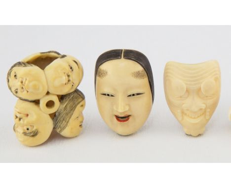 A Japanese carved ivory Shakumi mask netsuke Meiji period, with polychrome pigments, signed, 4.2cm. long; together with a car